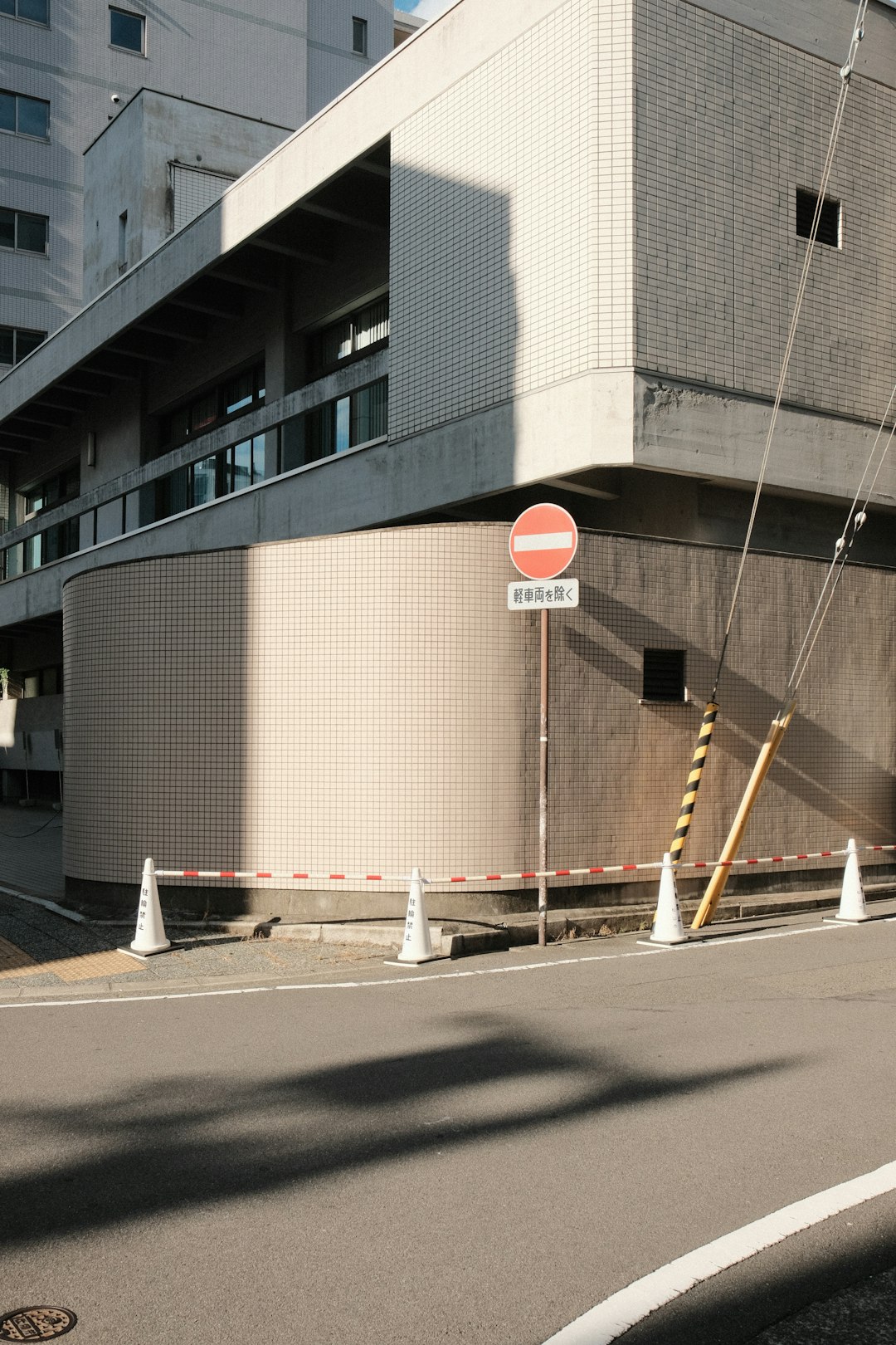 Modern building with a no entry sign and cones